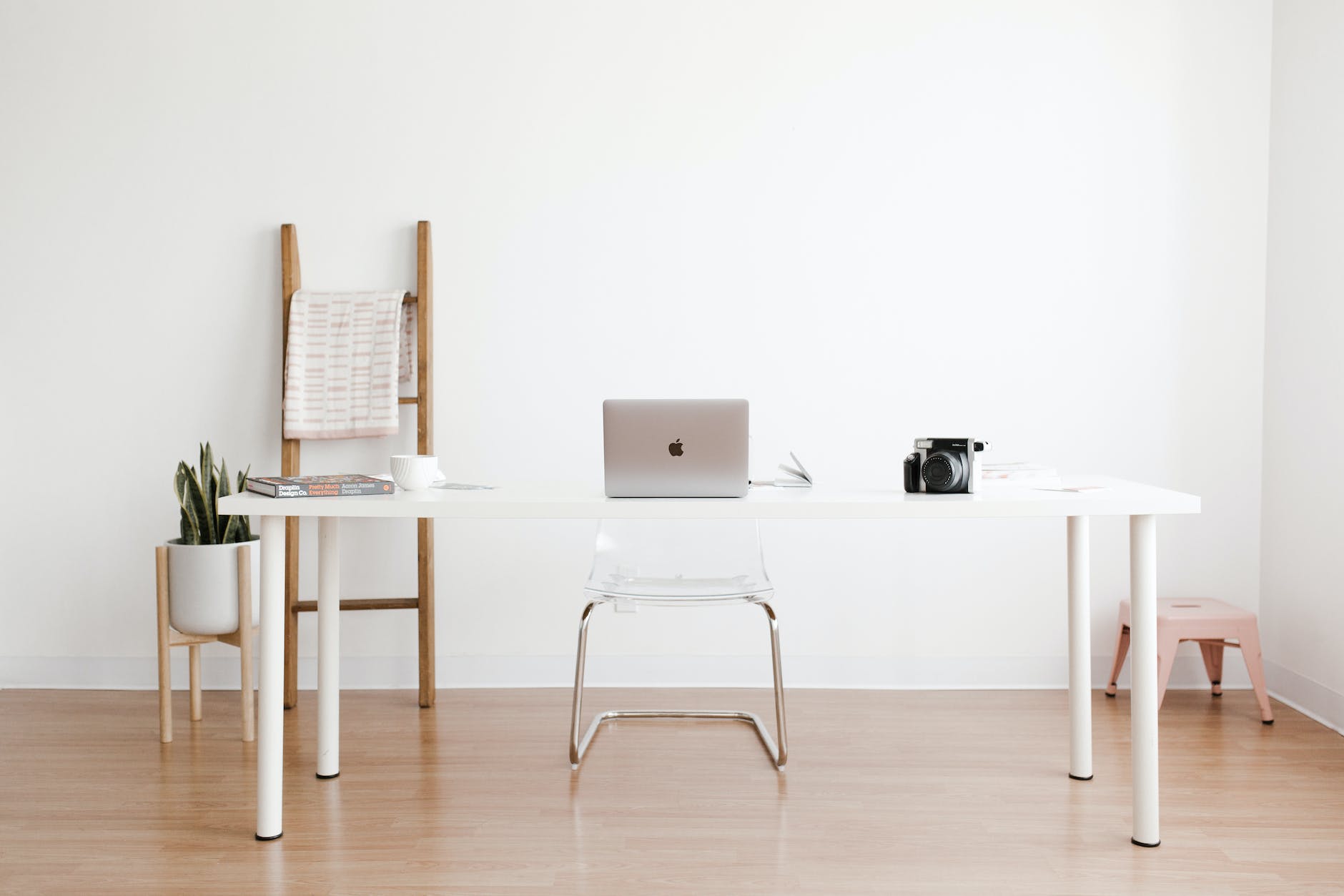 silver macbook on white table